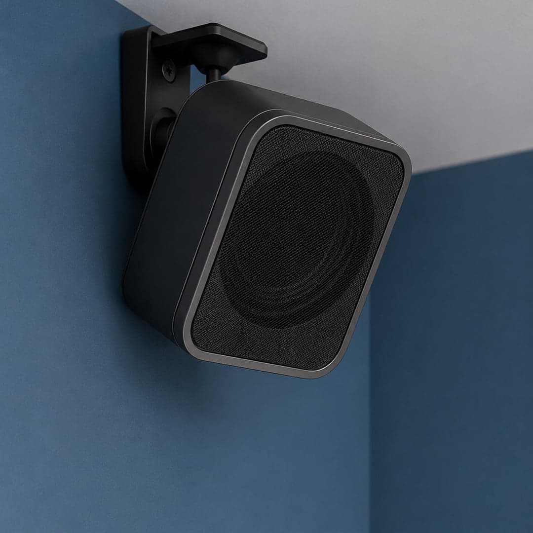 The compact CircuLight satellite speaker mounted on a bedroom wall.